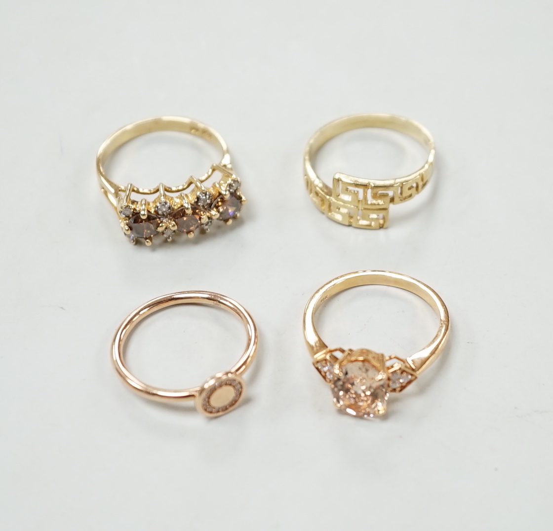 Three assorted modern 585 yellow metal and gem set rings, including two rose coloured and a 585 'Greek Key' ring, gross weight 11.1 grams.